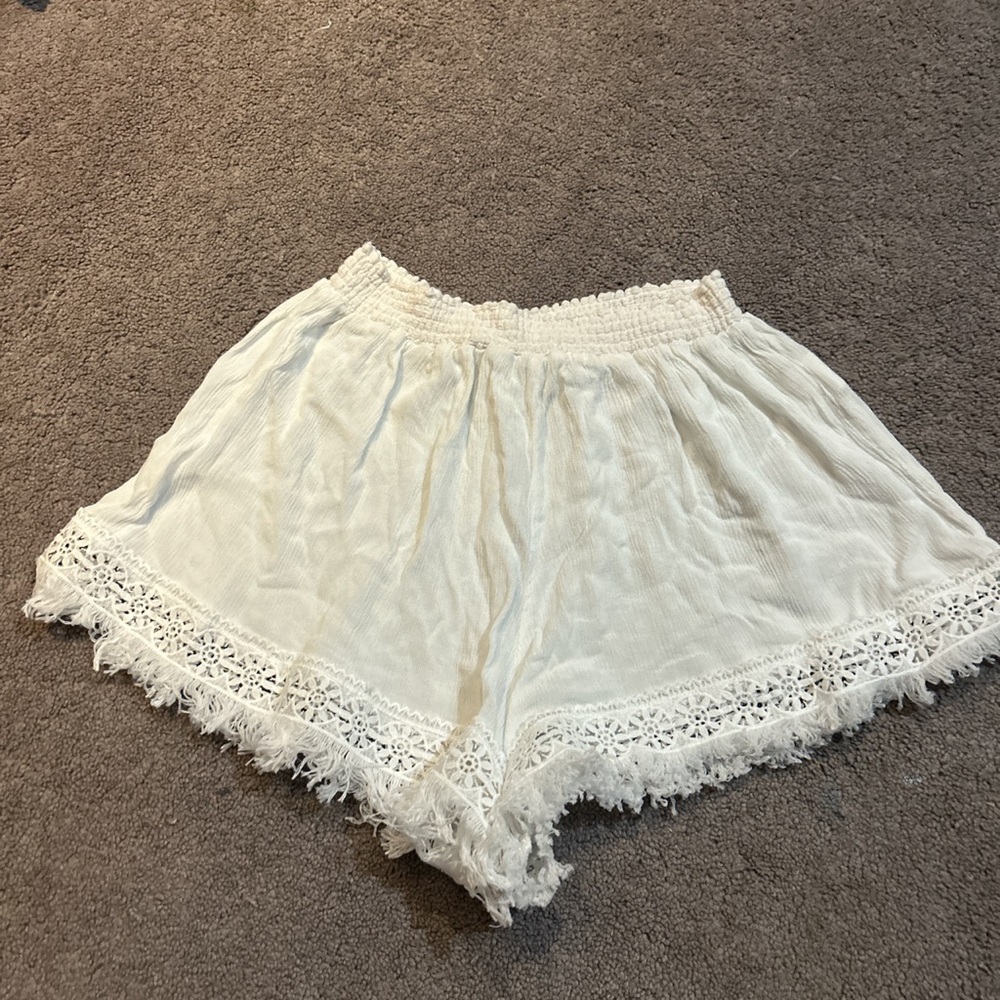 White elastic beach shorts with designing st the bottoms (size xl)